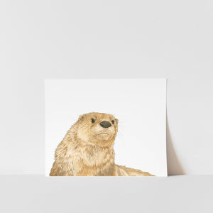 A print of an otter peeking from behind a white background, signed by artist Heather S Vitticore.