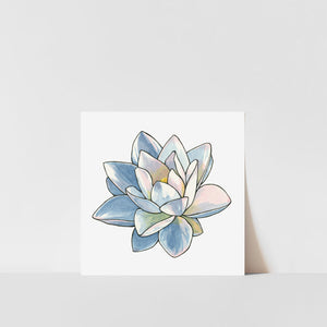 A printed art of a lotus flower with blue, pink, and white colors on a white background, with a visible signature at the bottom right corner.