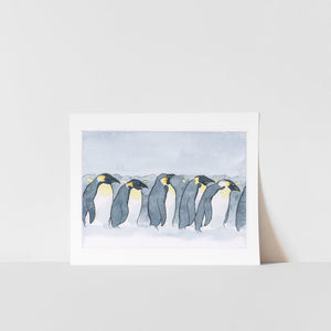 A print of a watercolor painting featuring a group of penguins on a white background, presented against a white background.